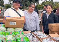 Three students at the food distribution